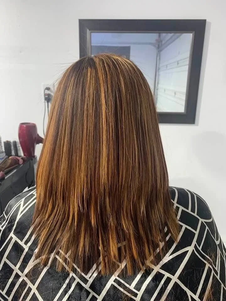 After: Sleek, straight hair with fresh caramel highlights.