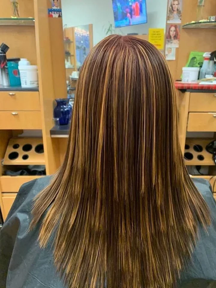 After: Straight hair with bold caramel highlights.