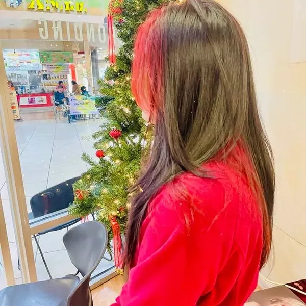 Long dark hair with bright red peekaboo streaks.
